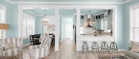 A spacious living room with a dining area, kitchen, and bar area.