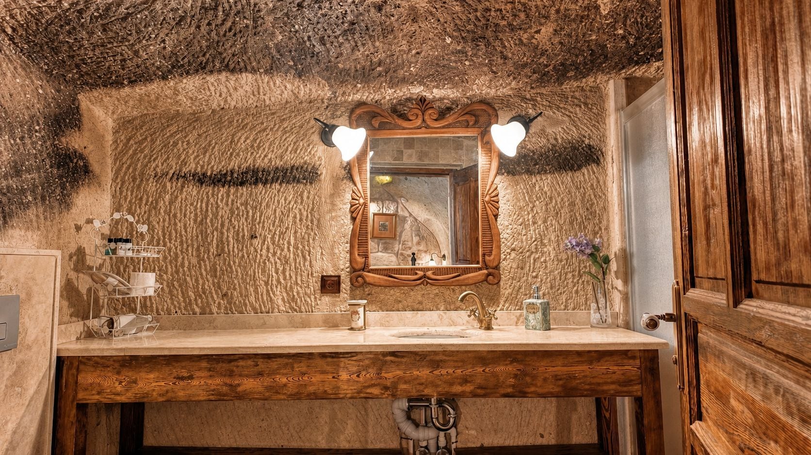A bathroom with a wooden vanity, a mirror with heart-shaped lights, and a rustic wall texture.