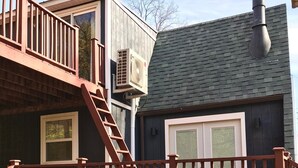 A wooden deck with a railing, a window, and a door. - Relaxing Scenic 1 Bedroom Retreat With Private Hot Tub (Findlay)