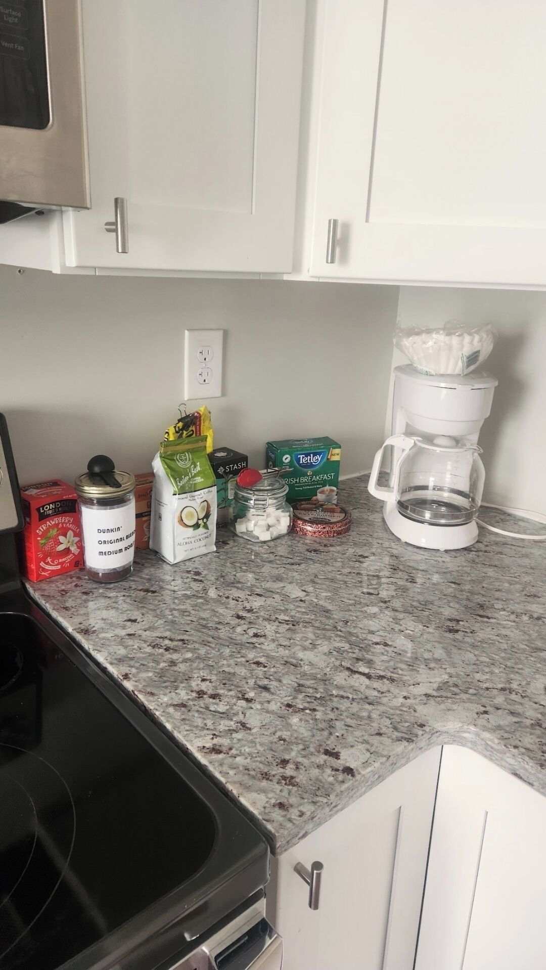 A kitchen counter with various food items and a coffee maker.