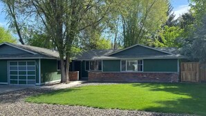 Une maison à deux étages avec un garage et un patio couvert.
