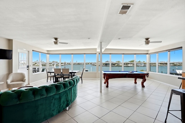 Welcome to Sunburst Vacation Rentals! The living/dining room/kitchen are open concept and the wall of windows give a 180 degree view of the blue waters of the intracoastal of Indian Rocks Beach! Play pool while you watch dolphins play!