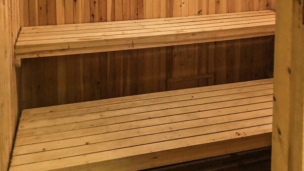 A wooden sauna with two benches.