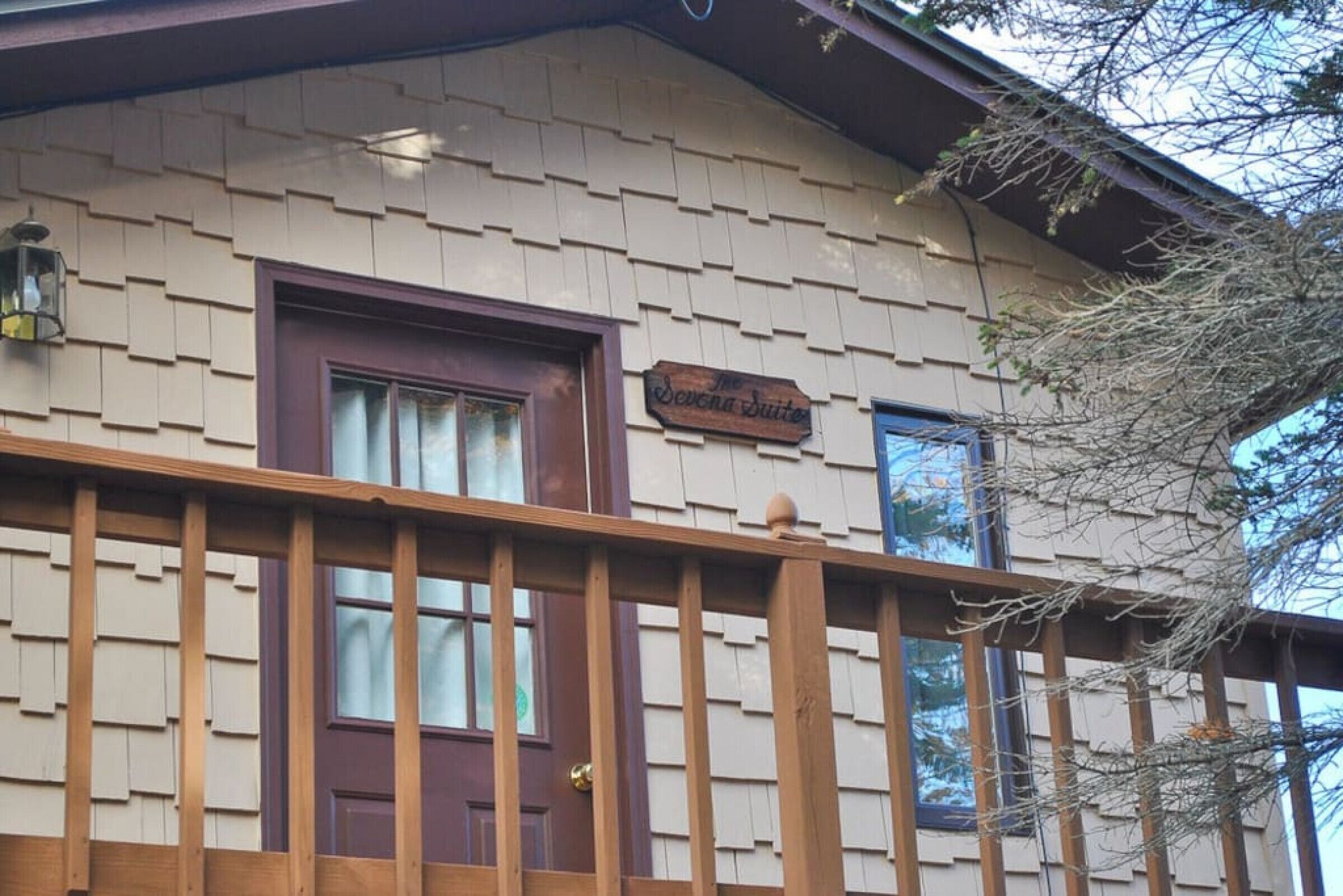 A wooden exterior with a sign reading "The Severn Suites."