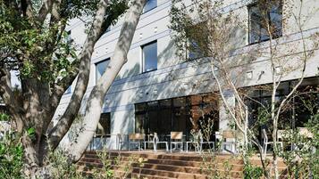 A modern building with a staircase leading to a seating area.