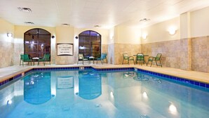 An indoor swimming pool with clear signage, green chairs, and a tiled wall. - Studio | Free Breakfast. Indoor Pool & Gym. (Oak Ridge)