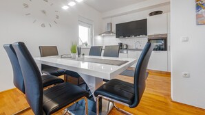 A modern kitchen with white cabinets, a built-in oven, and a large window. - Awesome apartment in Privlaka with WiFi (Privlaka)