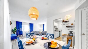 A modern kitchen with white cabinets, a built-in oven, and a coffee station. - Water View - Stocked - Palm Wave Says (Coconut Creek)