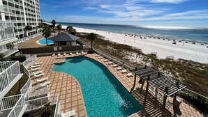 A resort with a pool, beach, and ocean view.