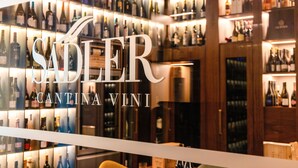 A wine store with shelves of various wine bottles. - Casa Baglioni Milan - The Leading Hotels of the World (Milan)