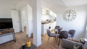Un appartement moderne comprenant un salon, un coin repas et une cuisine.