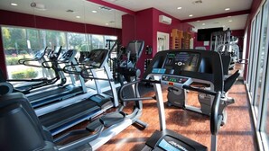 A gym with treadmills, elliptical machines, and weight equipment. - Near Disney: Townhouse w/ Resort Pool & Hot Tub (Kissimmee)