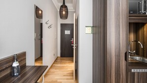 A modern kitchen with wooden cabinets and a built-in oven. - BoardingWorld Heidelberg (Heidelberg)
