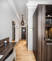 A modern kitchen with wooden cabinets and a built-in oven.