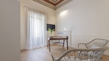 Enjoy dining and socializing in this elegantly furnished room with a classic design, featuring a dining table and chairs, a radiator, and a potted plant.