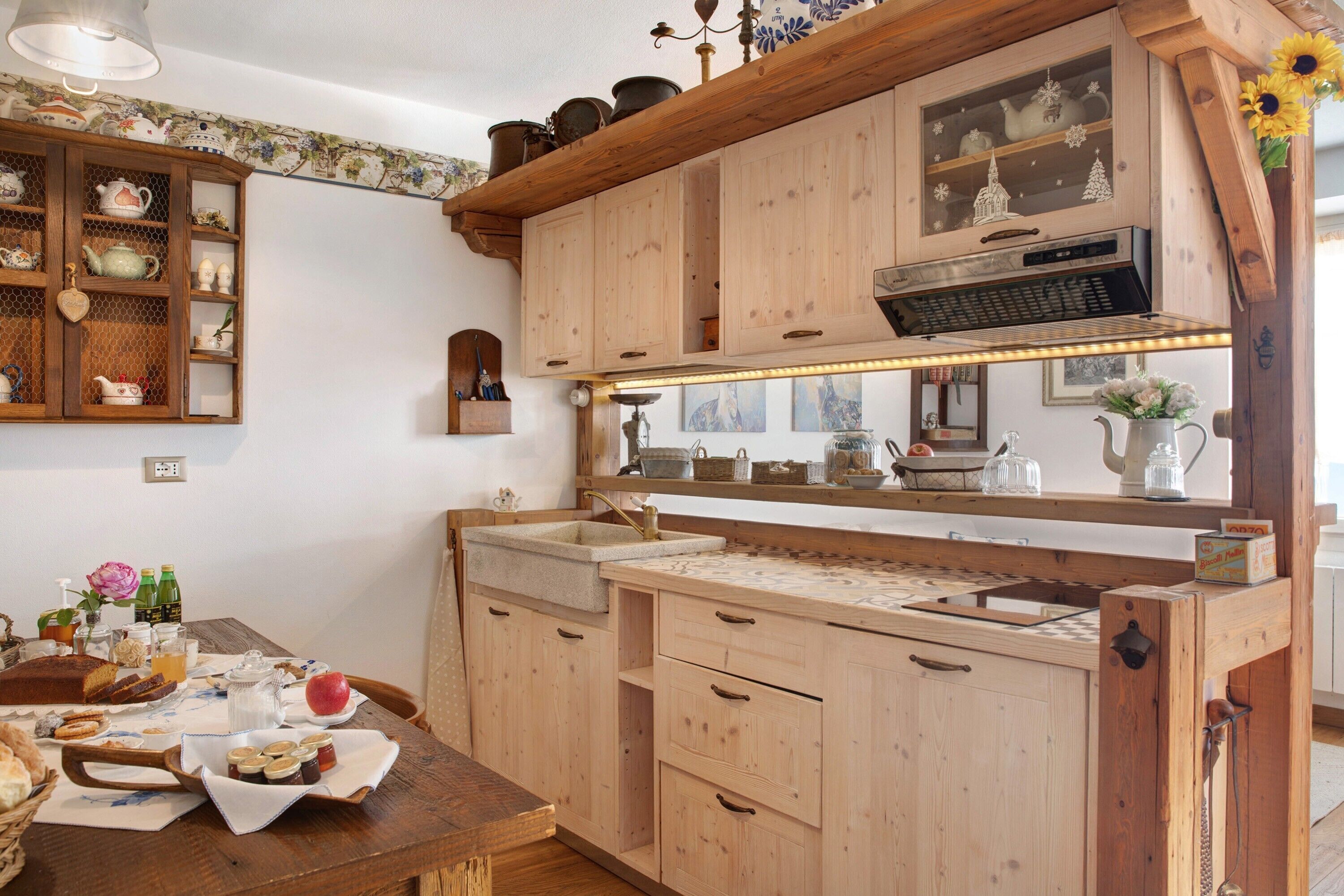A kitchen with wooden cabinets, a countertop, and a sink.