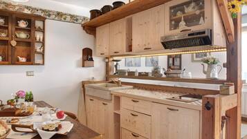 A kitchen with wooden cabinets, a countertop, and a sink.