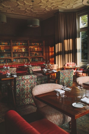 Relax in a quiet library lounge with comfortable seating and a vast book collection.