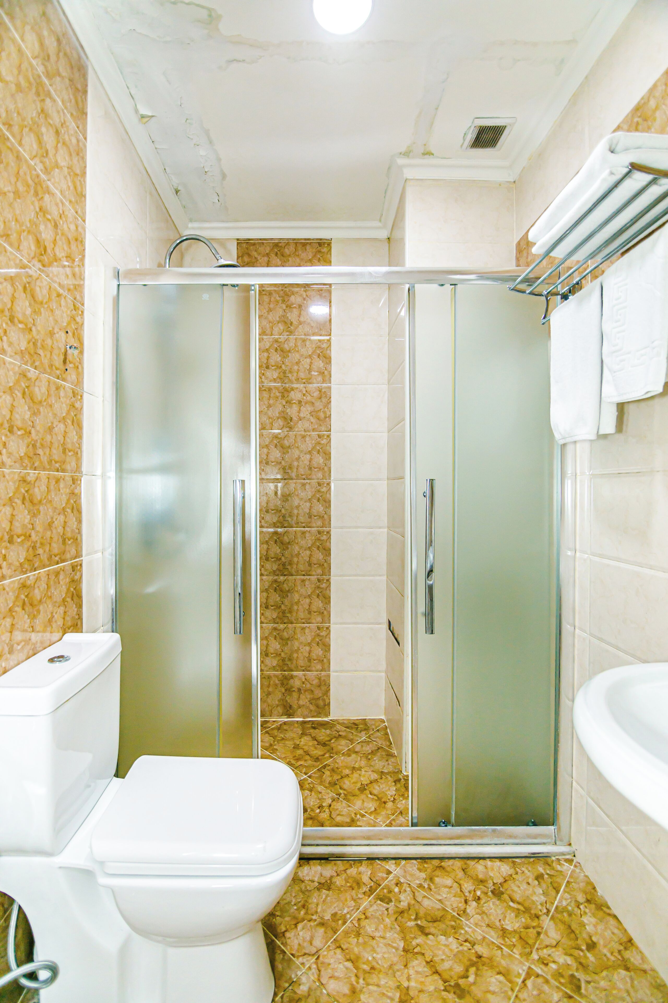 A bathroom with a glass-enclosed shower, a toilet, and a bathtub.
