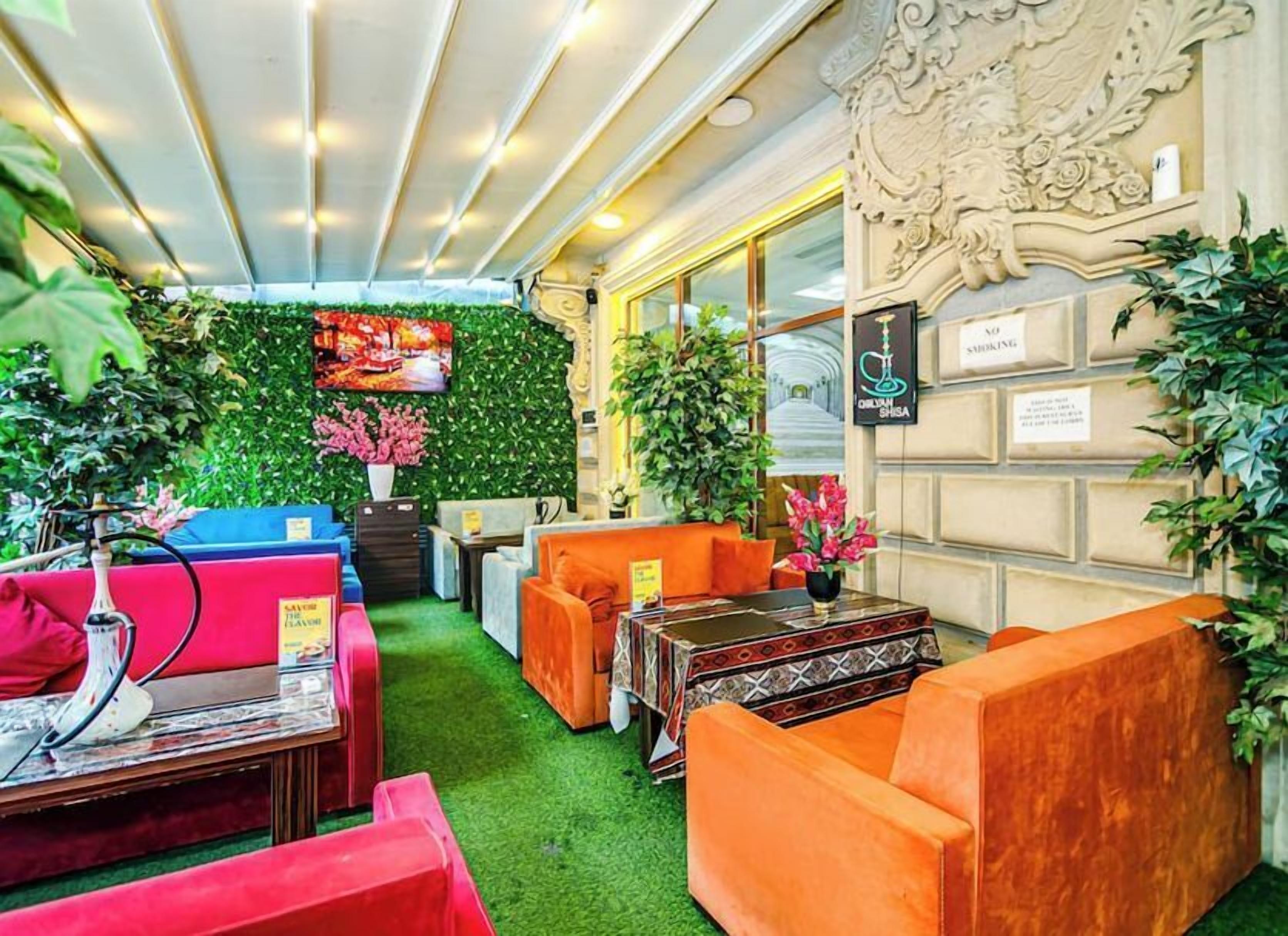 A cozy lounge area with sofas, a coffee table, and a wall-mounted TV.