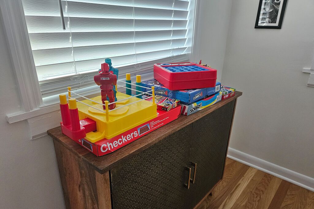 A wooden cabinet with a toy train set on top.