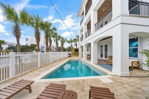 A pool area with lounge chairs, a white fence, and palm trees. - 30A Paradise! Pool, Tiki Bar & 6-Seat Golf Cart 5-Bed Book Now for Fall! (Santa Rosa Beach)