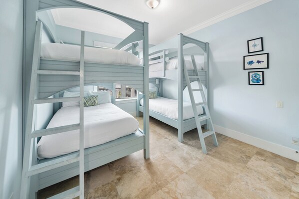 A room with bunk beds, a ladder, and a wall with framed pictures. - 30A Paradise! Pool, Tiki Bar & 6-Seat Golf Cart 5-Bed Book Now for Fall! (Santa Rosa Beach)