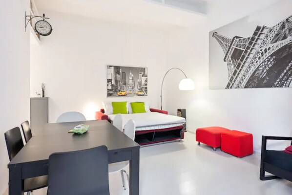Enjoy a comfortable stay in this stylish room with a neatly arranged bed, dining area, and city view.