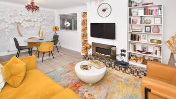 Relax in this stylish living room with a sofa, coffee table, and fireplace.
