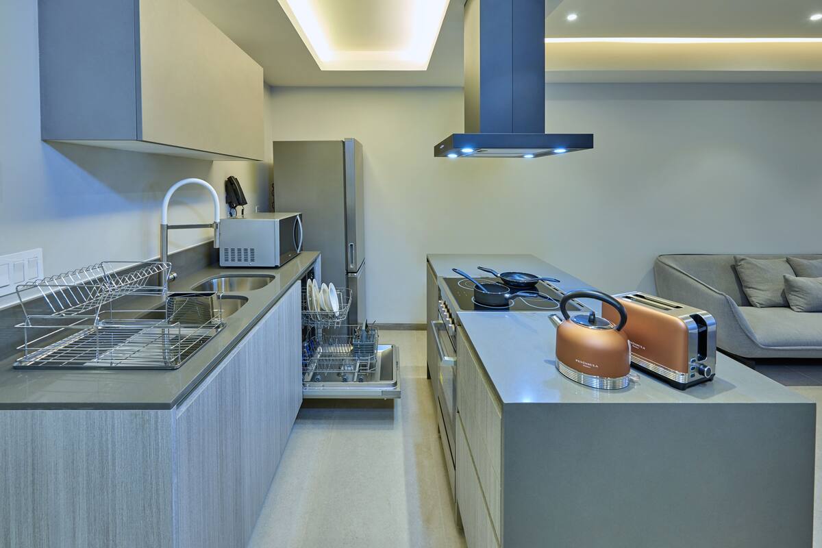 A modern kitchen with a built-in dishwasher, a microwave, and a toaster.