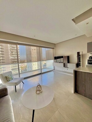 Deluxe Apartment | Living area | 32-inch flat-screen TV with cable channels, TV