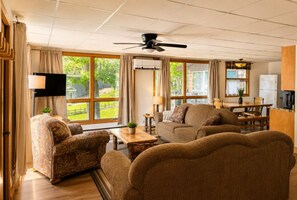 The living room is a bright and airy space, perfect for relaxing with stunning views of nature!
