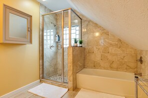 A modern bathroom with a glass shower enclosure, a bathtub, and a marble-tiled wall. - Chic Indianapolis Home w/ Yard Near Downtown! (Indianapolis)