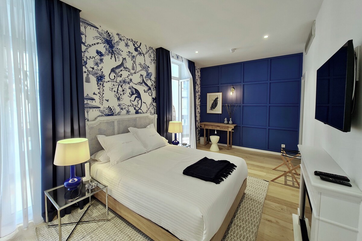 Premium bedding, desk, laptop workspace, blackout drapes