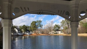 A gazebo with a view of a lake and houses in the background. - Tennis, Pools, Games. Huge 4BDR Powhatan Resort Villa. FIreplace. King Suites. (Williamsburg)