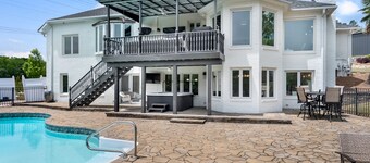 Beautiful Waterfront Home with abundant outdoor seating, pool, hot tub, grill