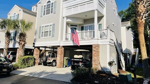 A two-story house with a garage, an American flag, and a mailbox. - Small Efficiency near Surfside Beach Pier (Surfside Beach)