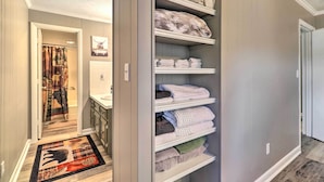 A walk-in closet with shelves for folded towels and blankets. - Welcoming Boone Getaway Near Hiking + Skiing! (Boone)