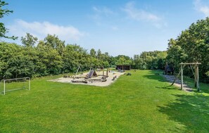 Enjoy family-friendly fun in this serene outdoor space with a swing set, slide, and climbing structure.
