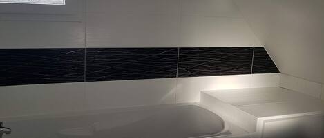 Bathtub, hair dryer, towels, soap