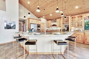 Enjoy cooking in this well-lit kitchen with a large island and stainless steel appliances.