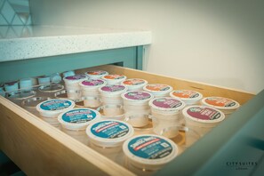 A wooden drawer with multiple containers of Swiss Miss hot cocoa mix. - Luxury Suite ~ Above Starbucks ~ Main St View (Logan)