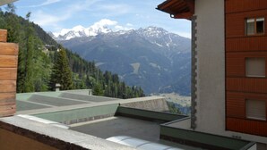 A building with a view of snow-capped mountains.
