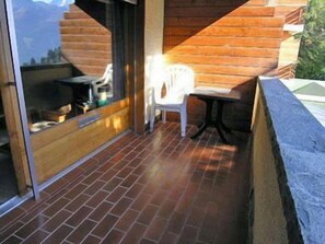 Enjoy a peaceful retreat with a mountain view from this outdoor space.