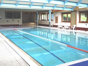 Swimmers can enjoy the pool with lane dividers and lounge chairs.