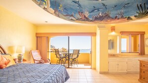 A hotel room with a bed, a dining table with chairs, a balcony with a view, and a bathroom with a mirror and sink. - Amazing 3BR 2Bath at the Princesa Resort A-505 Ocean View Condo (Puerto Peñasco)