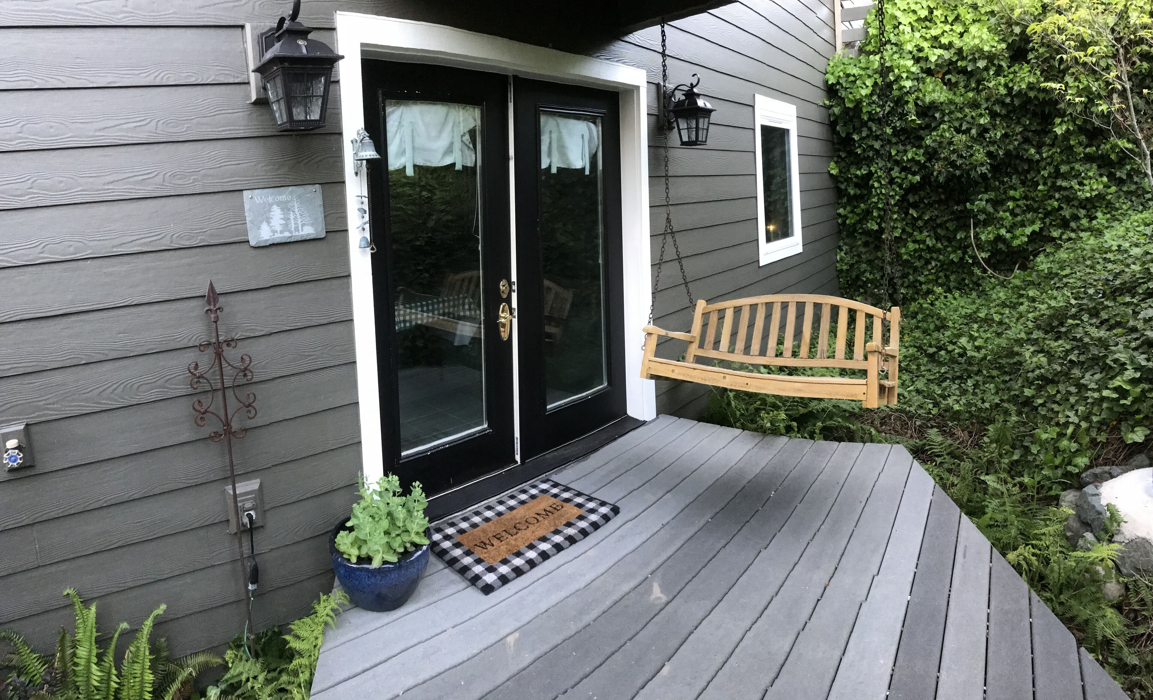 Lower deck off media room with French doors/swing/BBQ/natural landscaping