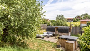 A backyard with a wooden deck, a covered barbecue area, and a small shed. - Studio Apartment "Belroki Ranch" with Sauna, Terrace, and Garden (Waldeck)