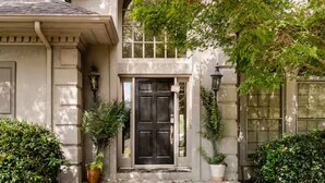 A stately house with a prominent entrance, a large black door, and a stone facade. - 5000Sqft MassiveHome,5.5Bath,Pool,HotTub,Mins to CopperCreekTennis, Fort-Benning (Columbus)
