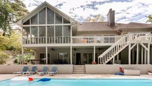 A two-story house with a swimming pool, a covered patio, and a staircase leading to a balcony. - 5000Sqft MassiveHome,5.5Bath,Pool,HotTub,Mins to CopperCreekTennis, Fort-Benning (Columbus)